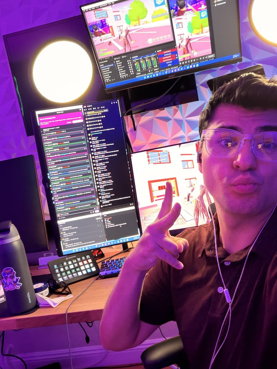 Boomer throwing up a peace sign at his streaming setup, with Fortnite and stream chat on the monitors behind him
